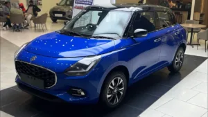 New 2025 Maruti Suzuki Swift top model in striking blue with black roof shown in showroom